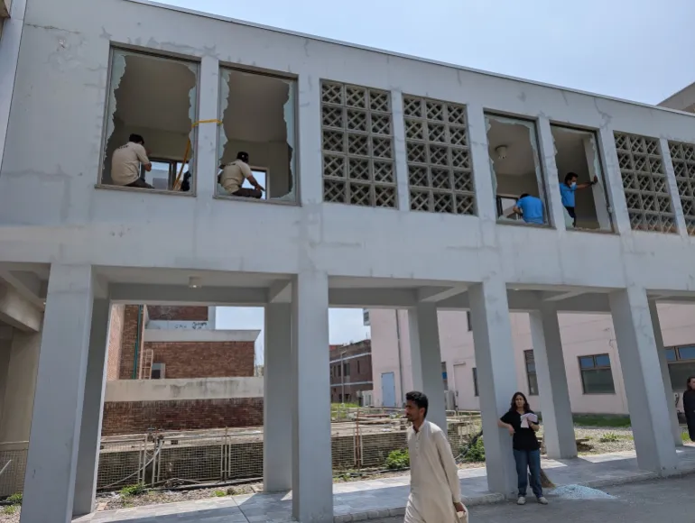 Broken windows at the PIMS building housing the nursery, hours after the August 26 fire. [Abid Hussain/Al Jazeera]