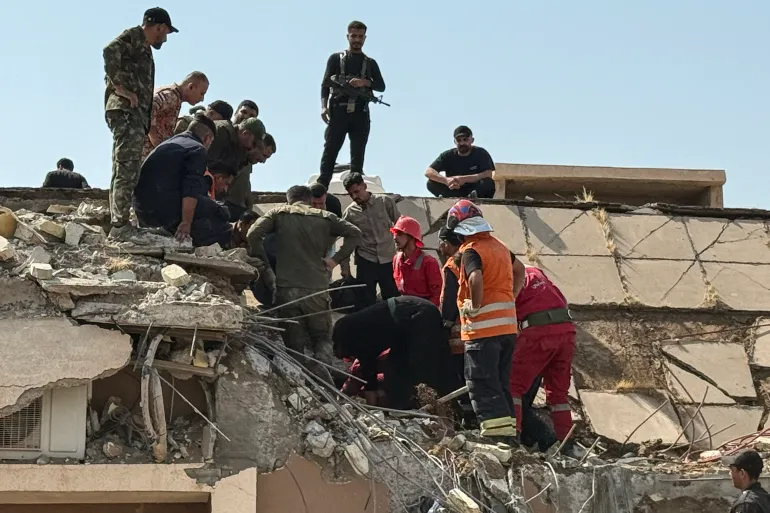 TOPSHOT - Security forces and emergency personnel work at the site of a strike north of al-Miqdadiyah district in Iraq's Dayala province on July 29, 2026.