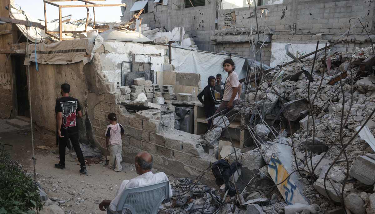 Displaced Palestinians gather amid the rubble of a heavily damaged building being used as a shelter in Khan Yunis in the southern Gaza Strip on September 19, 2026.— AFP