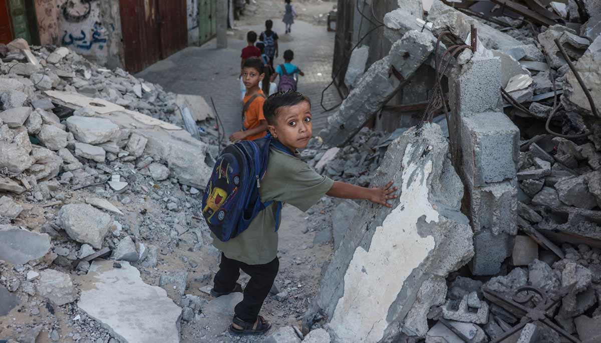 Palestinian children walk to school amid the rubble of destroyed buildings as the academic year begins in Khan Yunis, in the southern Gaza Strip on September 19, 2026.— AFP