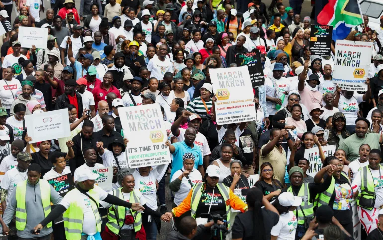 Protesters hold placards during an anti-immigration march in Durban, South Africa, calling for tighter border controls and the deportation of undocumented migrants [Thuli Dlamini/Reuters]