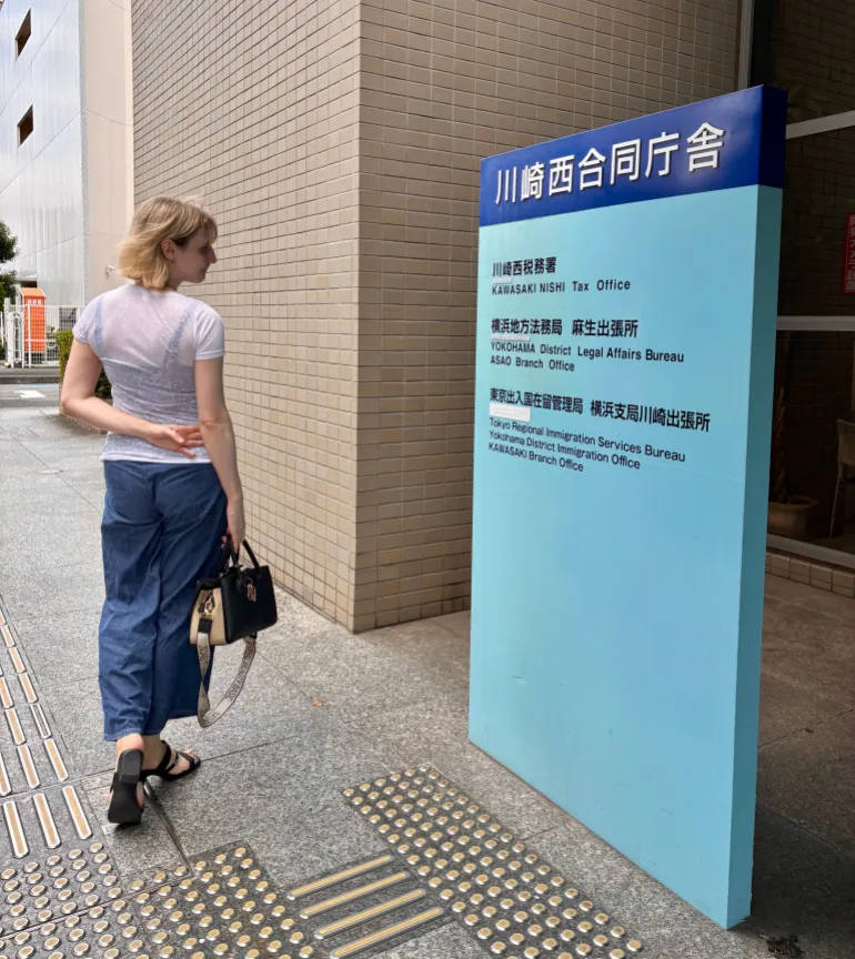 Sarah Nelkin stands outside the Kawasaki Branch Immigration Office in Kawasaki, Japan, on August 18, 2026
