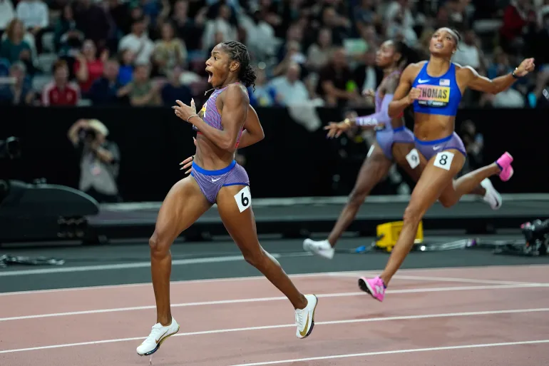 Melissa Jefferson-Wooden, of the United States, crosses the finish line ahead of Gabrielle Thomas and Kayla White, 2nd right, both also of the United States, to win the women's 200 meters final at the World Athletics Ultimate Championship in Budapest, Hungary, Sunday, Sept. 13, 2026. (AP Photo/Matthias Schrader)