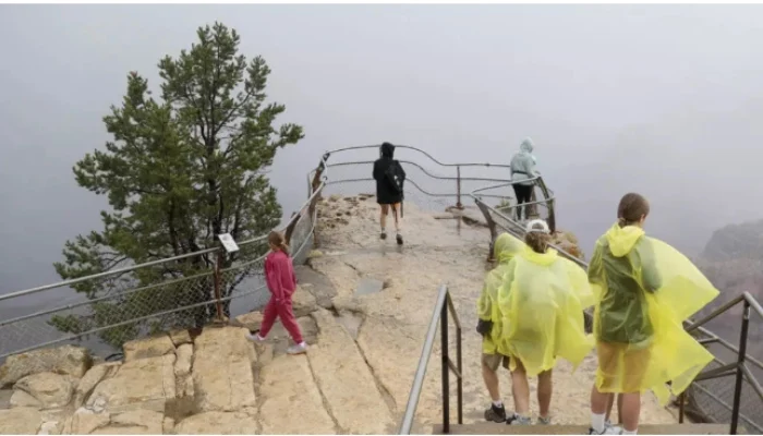 Visitors gather at an overlook of the Grand Canyon on August 31, after a deadly flash flood hit the famed national park. — AFP/File
