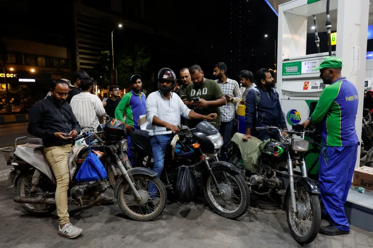 People wait to refuel their motorcycles at a petrol station following the rollout of a fuel relief scheme, which provides a fuel subsidy for eligible motorcycles, rickshaws and vehicles with engines of up to 800cc, in Karachi, Pakistan, September 17, 2026. REUTERS/Akhtar Soomro