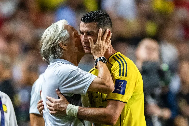 Al-Nassr's head coach Jorge Jesus (L) embraces Cristiano Ronaldo as he gets substituted during the Saudi Super Cup semi-final football match between Al-Nassr and Al-Ittihad at the Hong Kong Stadium in Hong Kong on August 19, 2025. (Photo by Wun Suen / AFP)